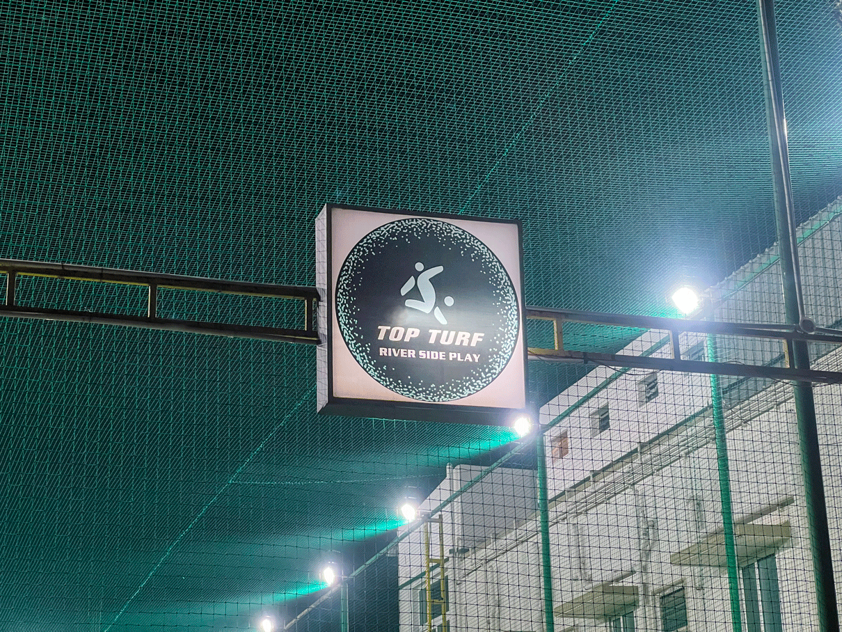 Top Turf in Sathy, Tamil Nadu with well-lit floodlights at dusk