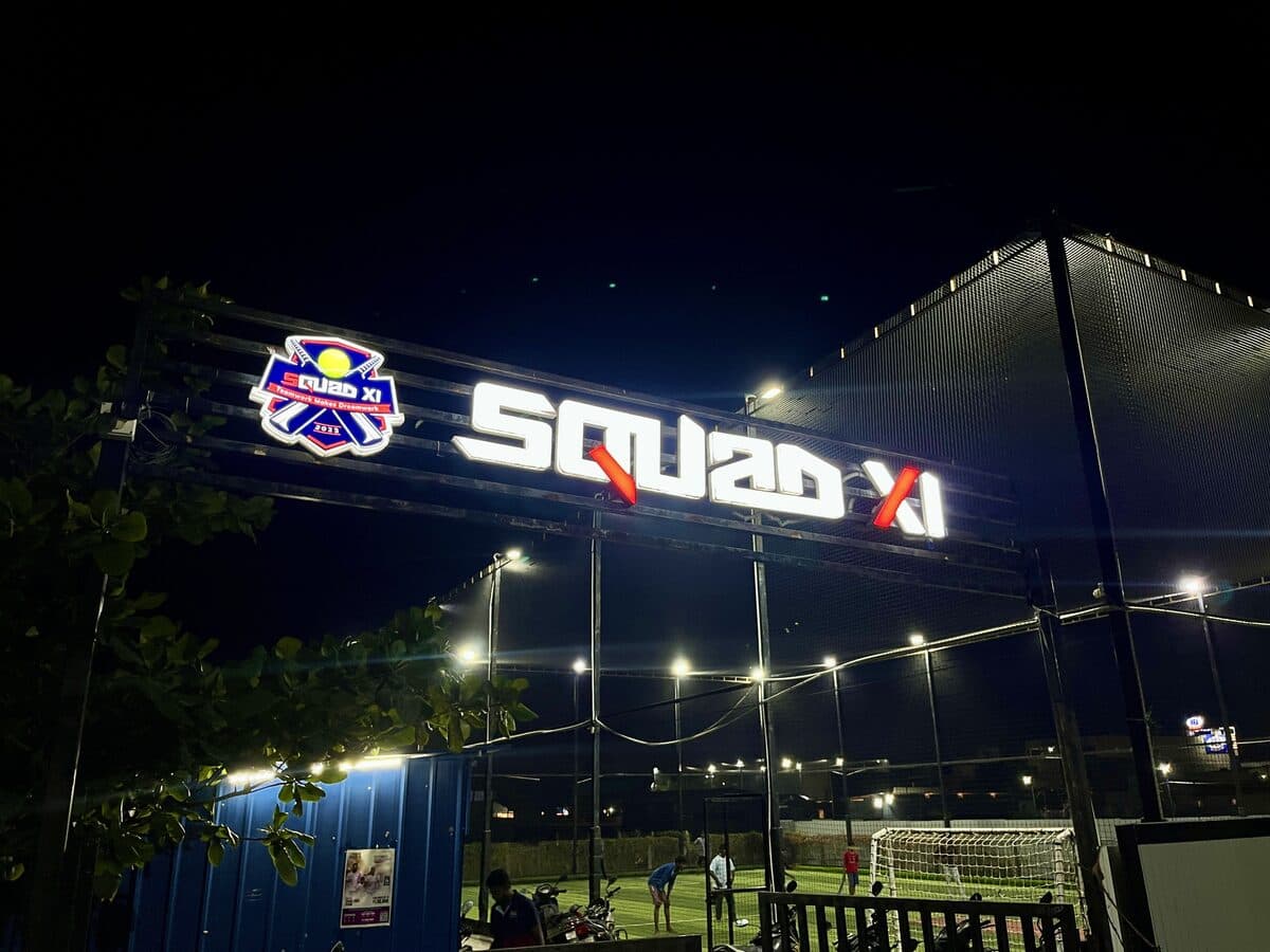 SQUAD XI cricket ground in Gobichettipalayam with well-lit floodlights at dusk